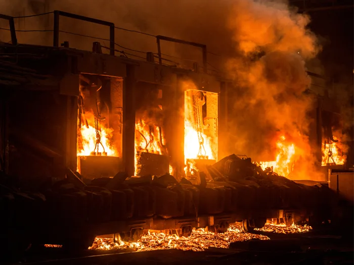 Gebäude, welches komplett in Flammen steht und nur noch Träger hat bei Nacht.
